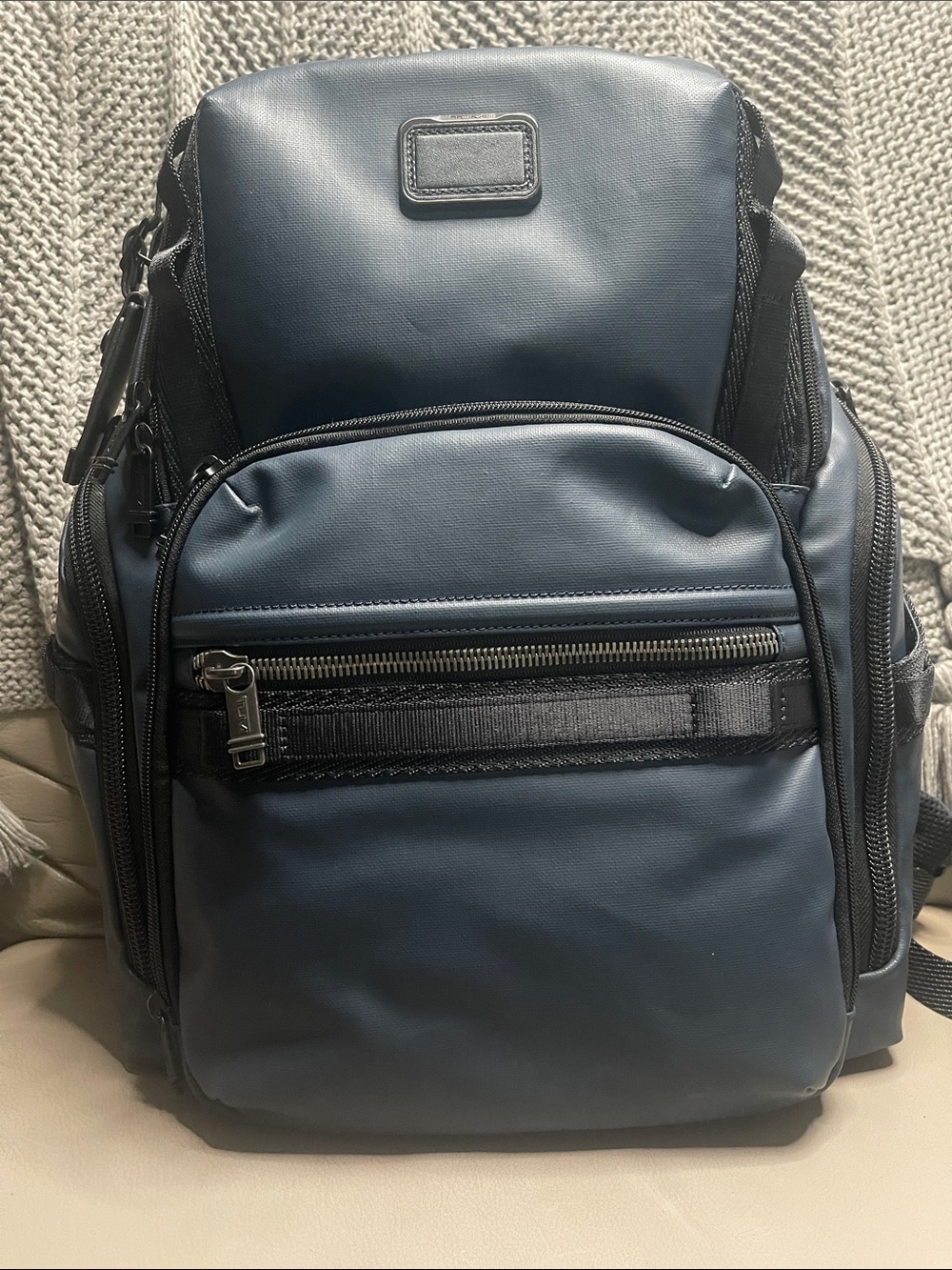 Tumi Men's Blue Travel Backpack with Front Zip Pocket.  It has never been used